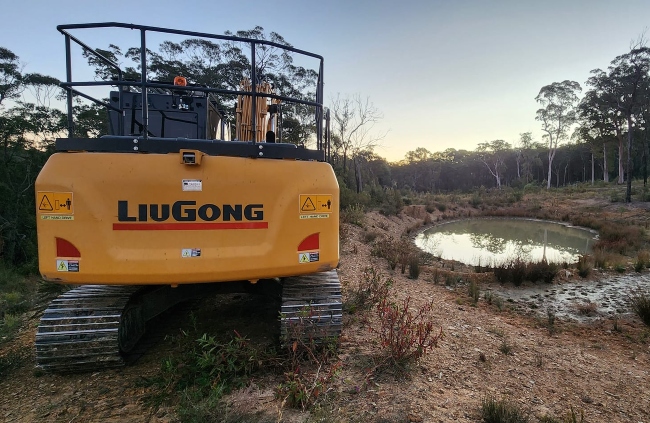 Dam construction completed with excavator on site in bushland by Rural Property Services NSW Dam construction completed with excavator on site in bushland by Rural Property Services NSW