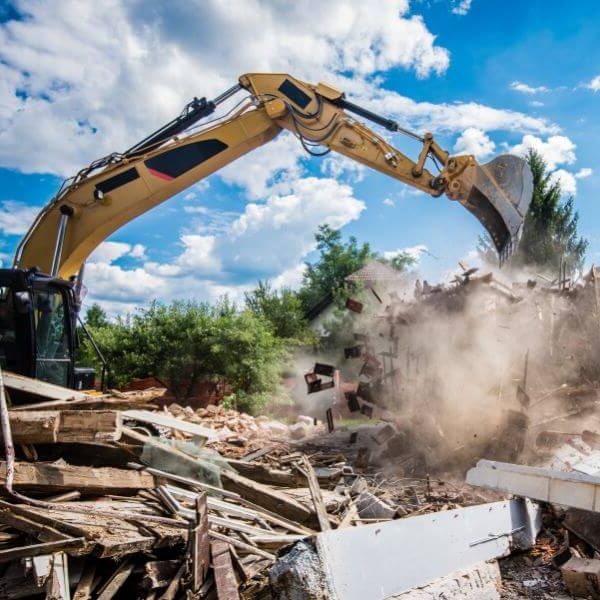 Excavator working through a demolition and rubbish removal job in a remote location