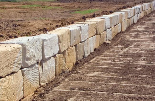 Sandstone block retaining wall built on a rural property with compacted ground, retaining wall construction by Rural Property Services NSW. Sandstone block retaining wall built on a rural property with compacted ground, retaining wall construction by Rural Property Services NSW.