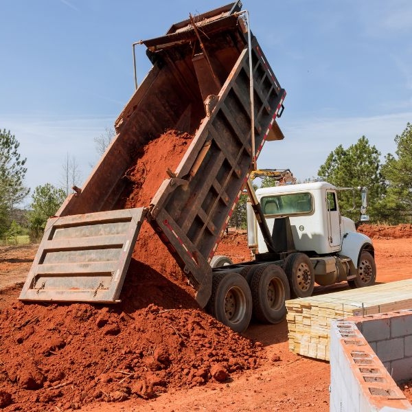 Soil being delivered to a rural block with heavy haulage truck during material supply job by Rural Property Services NSW