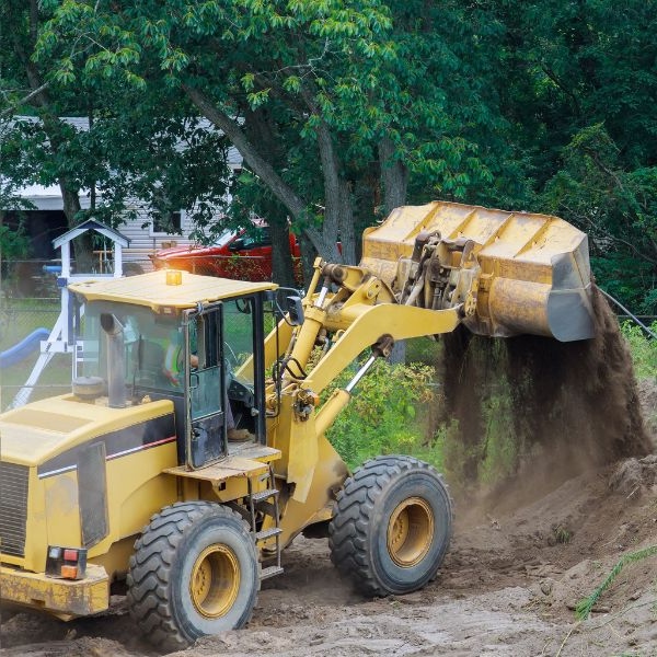 Heavy loader cutting through thick scrub during land clearing in Kenthurst by Rural Property Services NSW, making way for track grading and site shaping.